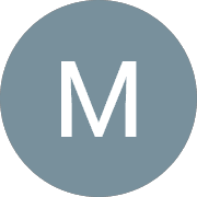 White sans-serif letter M centered on a solid muted blue-gray circular background.
